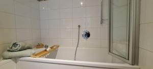 a bathroom with a shower and a bath tub at Spessartblick Eisingen in Eisingen +18 photos
