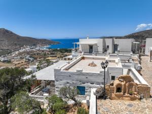 a large white house with a view of the ocean at Skopelitis Village in Katapola