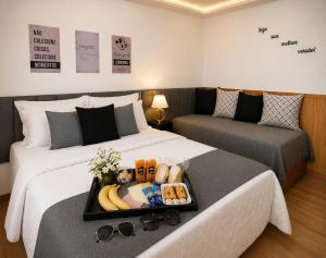 a hotel room with two beds with a tray of food at Casa da Marquês in Petrópolis