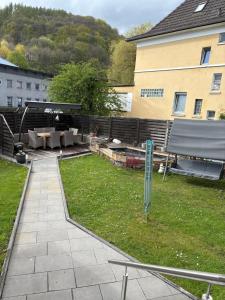 a backyard with a picnic table and a bench at Sauerlandapartment Emely in Plettenberg