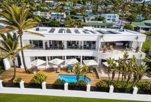 an aerial view of a house with a swimming pool and palm trees at Vetho House in Ballito