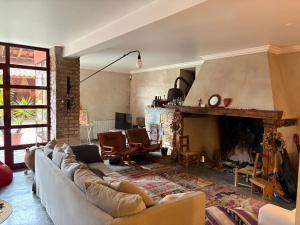 a living room with a couch and a fireplace at Casa da Mata in Torres Novas