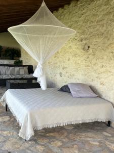 a bed with a mosquito net on top of it at Casa da Mata in Torres Novas +115 photos