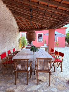 a large wooden table and chairs in a patio at Casa da Mata in Torres Novas