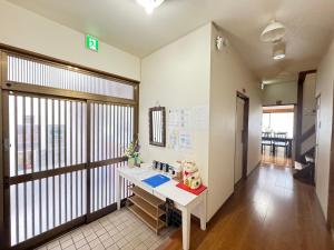 an office with a desk and a large window at Waraku No2,Guesthouse near KIX in Izumi-Sano