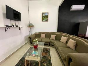a living room with a couch and a table at Heliconia Suite 5min to Waterfall - Shared Pool Pool in Fortuna