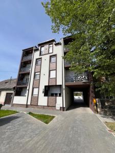 a building with a parking garage in front of it at Studio Vila Alto in Vrbas