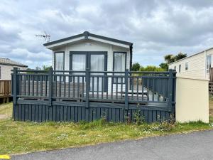 a small house with a gate and a fence at 820 Ocean View, Lydstep Haven Beach in Tenby