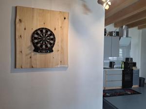 a dart board on a wall in a kitchen at Pension Garage in Kutná Hora +16 photos