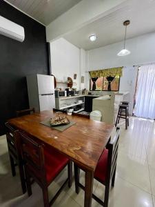 a large kitchen with a wooden table and chairs at Heliconia Suite 5min to Waterfall - Shared Pool Pool in Fortuna