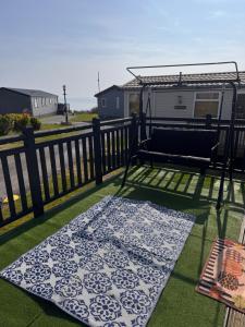 a rug on a balcony with a rv at 820 Ocean View, Lydstep Haven Beach in Tenby