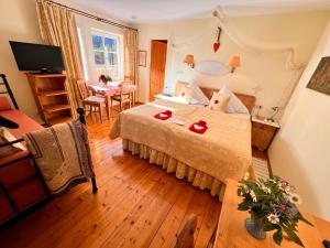 a bedroom with a bed with a red heart on it at Hannas ALPENGRUSS Apartment & Zimmer in Seefeld in Tirol