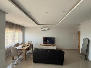 a living room with a couch and a table at Miles Dreams Laginha in Mindelo