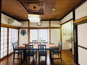 a dining room with a table and chairs at Waraku No2,Guesthouse near KIX in Izumi-Sano