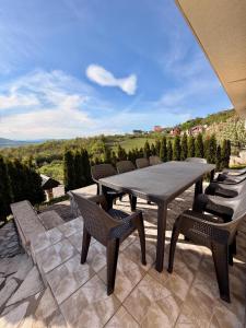a table and chairs on a patio with a view at Villa Rest Ilijas 4 bedrooms in Ilijaš