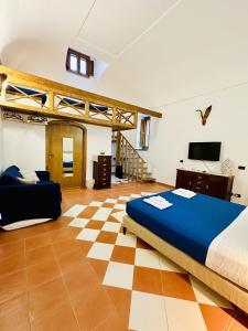 a bedroom with a bed and a checkered floor at L'Antico Episcopio in Scala