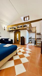 a bedroom with a bed and a checkered floor at L'Antico Episcopio in Scala +76 photos