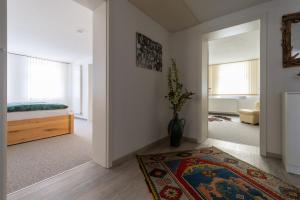 a bedroom with a bed and a vase of flowers at Kerstins Lieblingsdomizil in Oelsnitz +17 photos