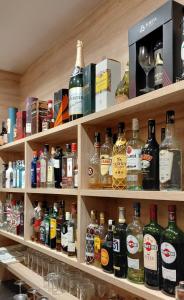 a shelf filled with lots of bottles of alcohol at Mirador de Aledo in Aledo