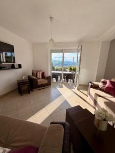 a living room with a couch and a table at Villa Rest Ilijas 4 bedrooms in Ilijaš