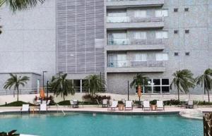 a swimming pool in front of a large building at Aqualand resorts 1Q in Salinópolis