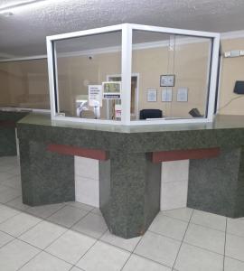 a counter in an airport with a ticket booth at Dover Inn in Dover