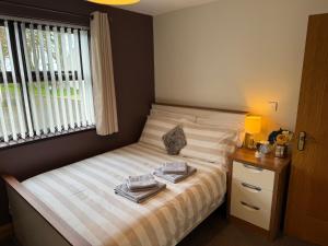 a bedroom with a bed with two towels on it at Marions Place in Finvoy