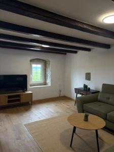 a living room with a couch and a flat screen tv at Vila EVANA in Sečovlje