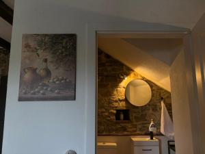a hallway with a painting of vases on the wall at Vila EVANA in Sečovlje +32 photos