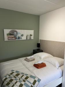 a bedroom with a bed with a tray on it at Business Accommodation 'Comfort Living' in Geel