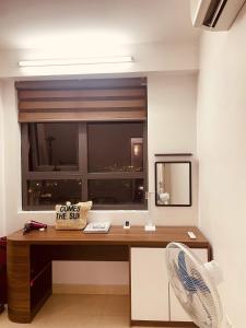 a room with a desk with a window and a fan at The Timegarden Homestay in Ha Long +22 photos