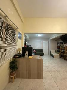 a living room with a couch and a table at The Station Hostel in Sathani Ayutthaya