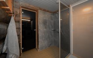 a bathroom with a shower with a glass door at Villa Poronperä in Kuusamo +54 photos