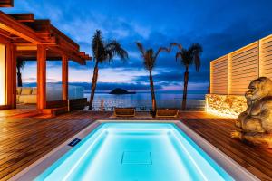 a villa with a swimming pool on a deck at Baba Residences in Alassio