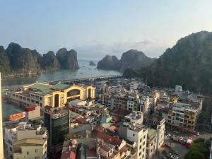a view of a city with mountains and a body of water at The Timegarden Homestay in Ha Long