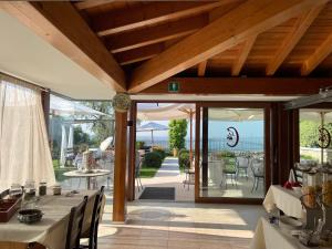 a dining room with tables and chairs on a patio at Casaliva Relais in Bardolino