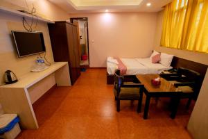 a hotel room with a bed and a table and a room at Rameshworam Hotel in Kathmandu +15 photos