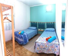 a bedroom with two beds and a mirror at Bella Vista in Torre Dei Corsari