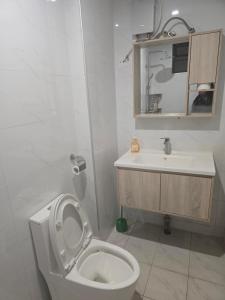 a bathroom with a toilet and a sink at Serene Studio near UN headquarters and Gigiri in Ruaka +4 photos