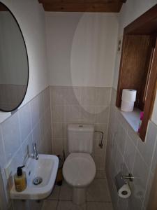 a bathroom with a white toilet and a sink at Port Griad in De Haan +8 photos