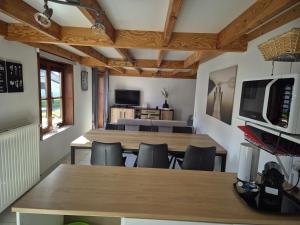 a dining room with tables and chairs and a television at Port Griad in De Haan