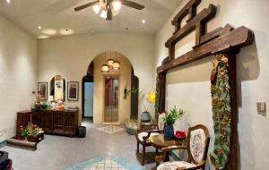 a living room with a table and chairs and a ceiling at Tranquility Suites Westlake in Hanoi