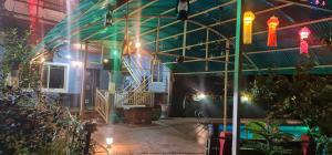 a room with lights on the side of a building at Bhogwal farm house in Karjat +2 photos