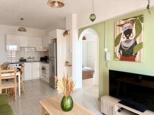 a kitchen and a living room with a fireplace at Coastal 2BR Apt in Mackenzie Steps from Beach by Cyprus Horizons in Scala