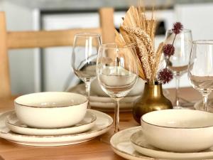 a table with plates and glasses of wine at Coastal 2BR Apt in Mackenzie Steps from Beach by Cyprus Horizons in Scala