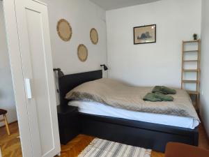 a small bedroom with a bed and mirrors on the wall at Galamb Odú Apartman in Baja