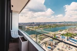 a balcony with a view of a river at Above Danube - Luxury Apartment in Vienna