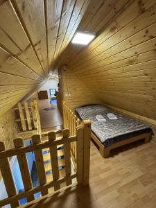 a room with a bed in a wooden cabin at Secret Forest Retreat in Ptujska Gora