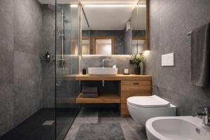 a bathroom with a sink and a toilet and a shower at CASA IBEX - Residence Veronza con piscina, Dolomiti Affitti in Cavalese