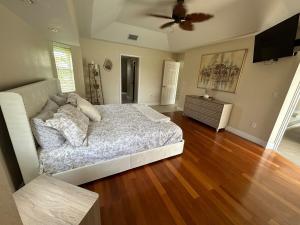 a bedroom with a bed and a ceiling fan at Salted Sunset at Punta Gorda Isles in Punta Gorda +83 photos